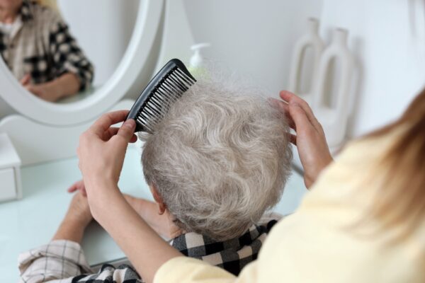 Woman,Brushing,Senior,Lady,With,Comb,Indoors,,Closeup